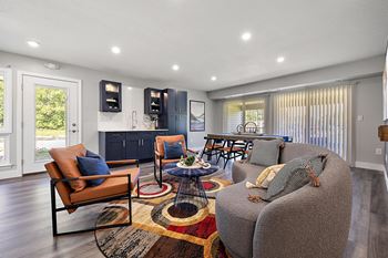 A living room with a grey couch and a brown chair.